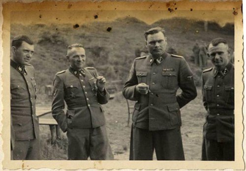 Hocker Album- Dr. Josef Mengele, Rudolf Höss, Josef Kramer, and an unidentified officer. —USHMM